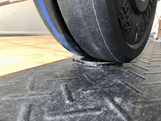 2.5 Pound Plate Wedged under a Bumper Plate
