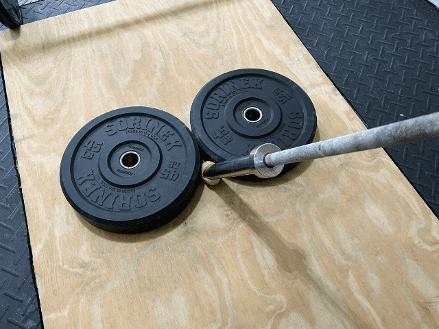 Barbell Wedged Between Two Plates